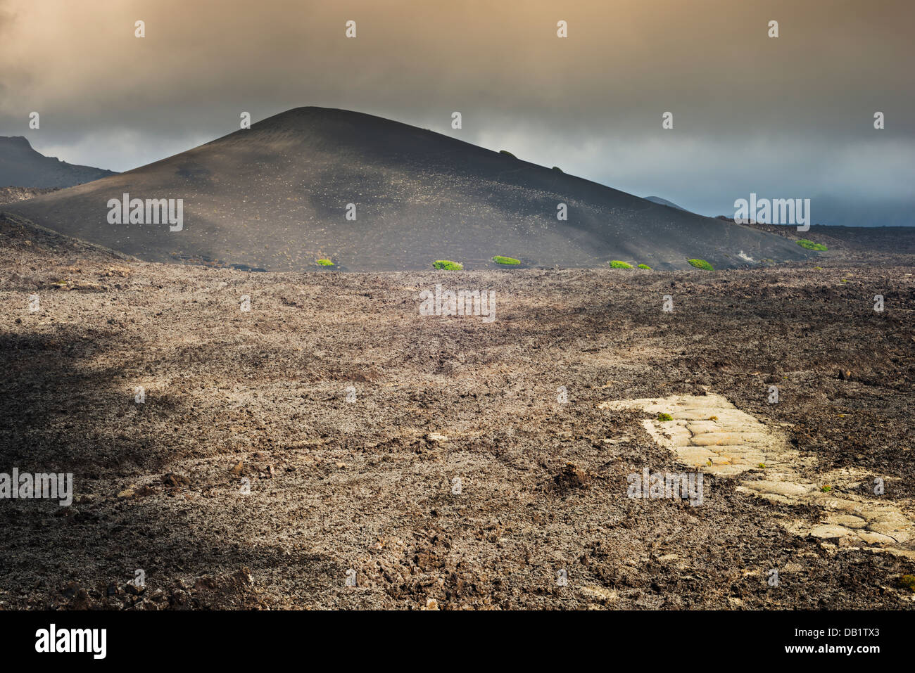 Aa lava field of the1730-36 eruption near Montana de Santa Catalina, Lanzarote, with strip of yellow lichen-covered pahoehoe Stock Photo