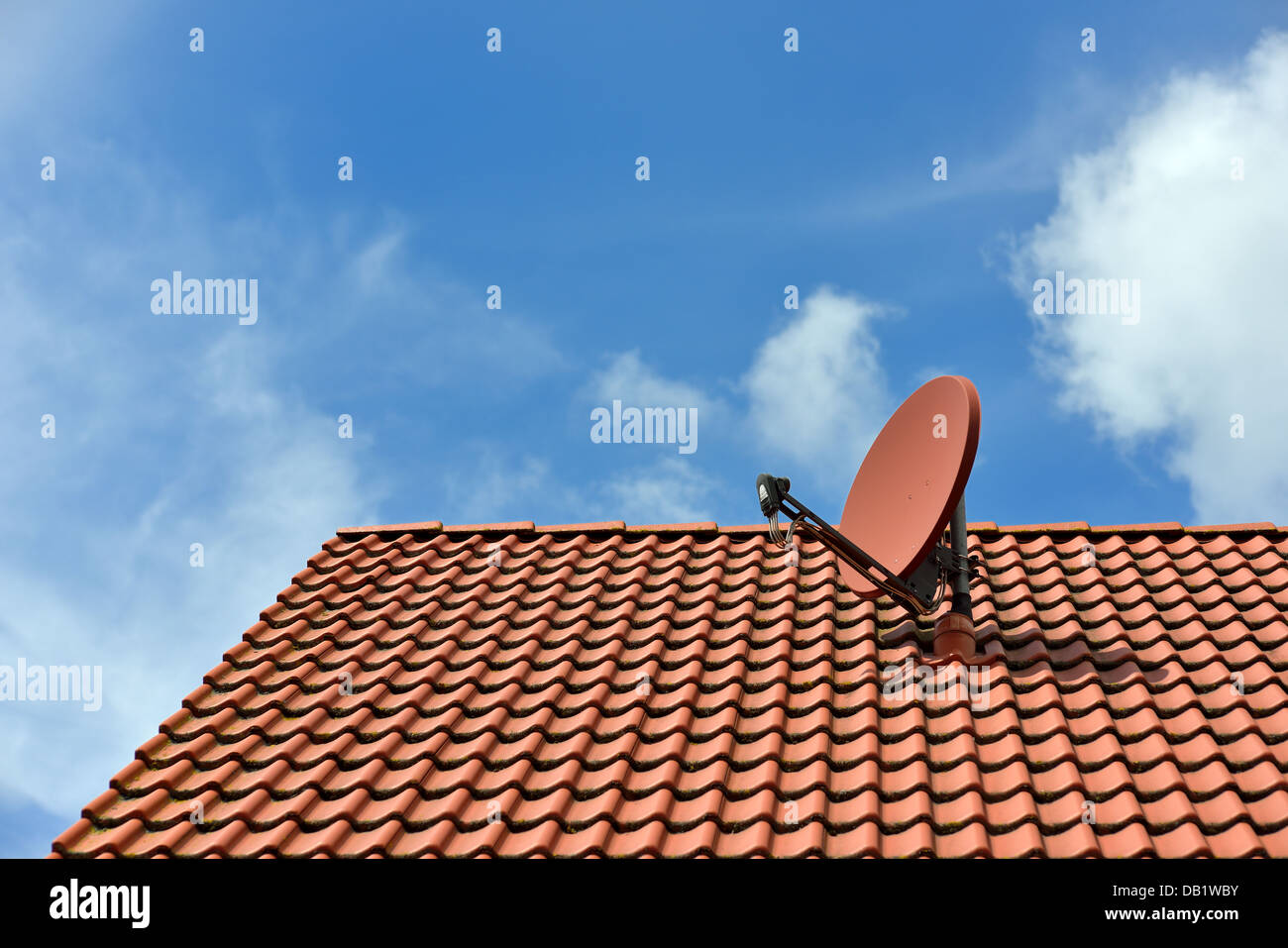 A satellite dish on a house roof Stock Photo