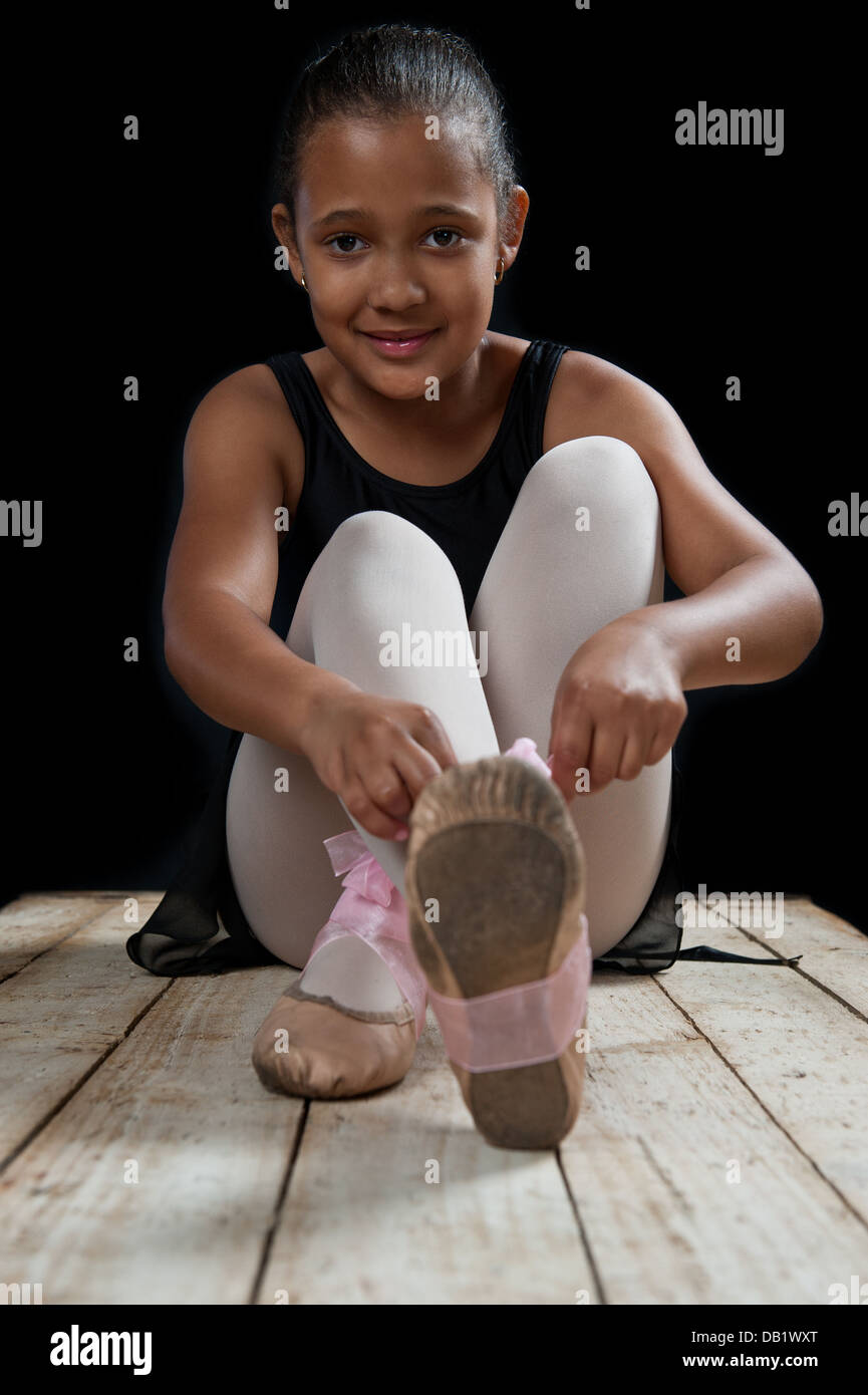 Young ballerina girl in a low key studio. More poses available. Stock Photo