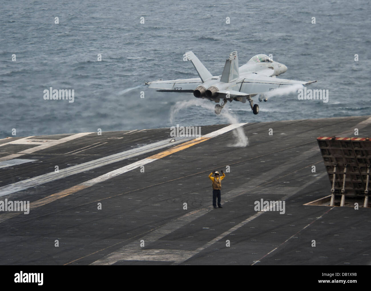 An F/A-18F Super Hornet assigned to the Black Knights of Strike Fighter Squadron (VFA) 154 launches from the flight deck of the Stock Photo