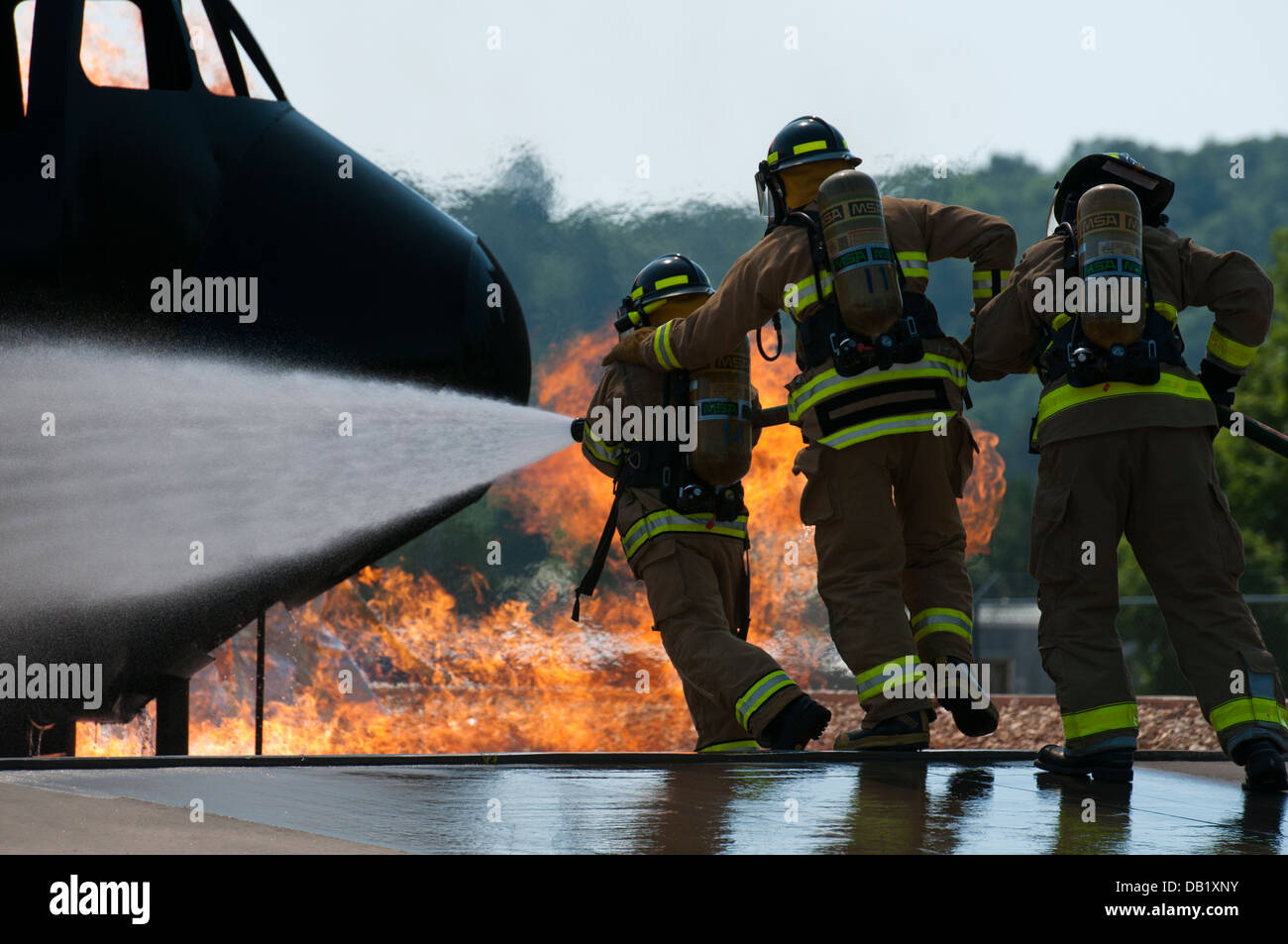 U.S. Army Reserve firefighters work to put out a fire at Volk Field Combat Readiness Training Center in Camp Douglas, Wis., July 18, 2013, during exercise Patriot 13. The Patriot exercise is a domestic operations scenario to assess the National Guard's ab Stock Photo