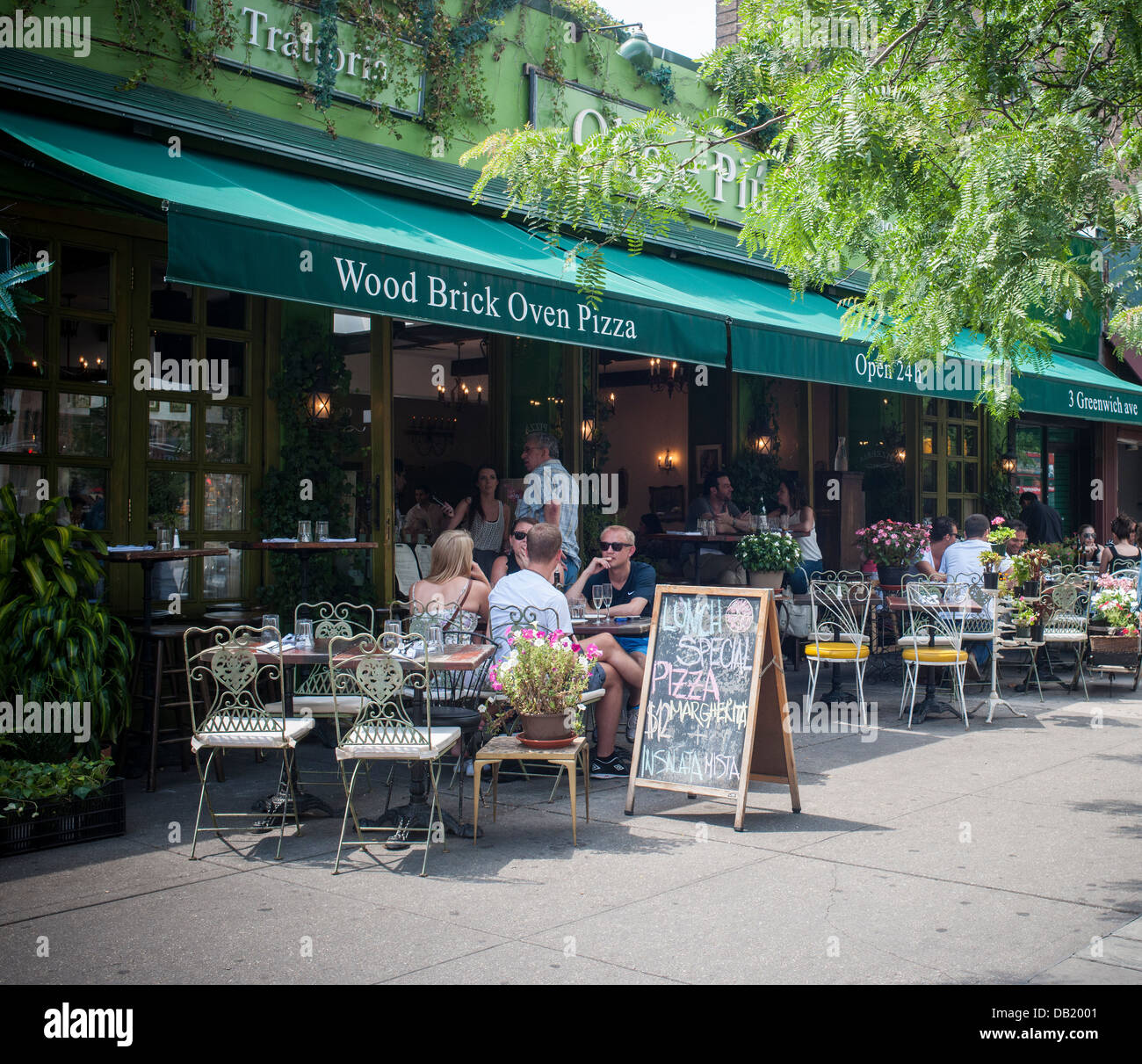 Busy al fresco dining at a pizzeria sidewalk cafe in the New York