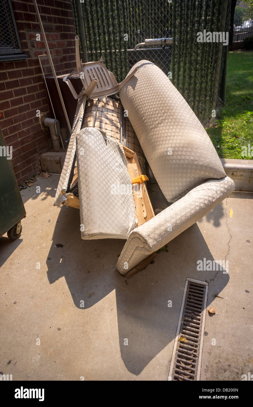 Couch awaits pick up by sanitation in the Chelsea neighborhood of New York on Friday, July 19