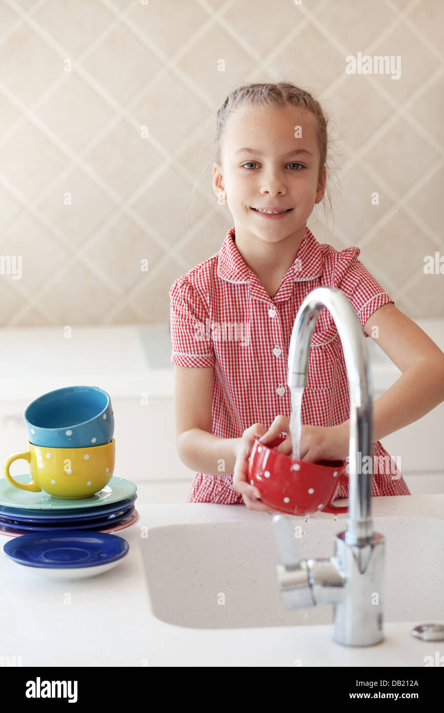 Little girl washing the dishes Stock Photo Alamy