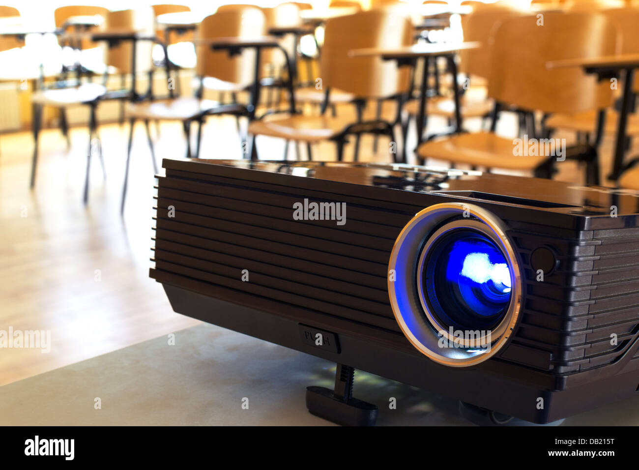 Turned on digital projector in a conference hall Stock Photo