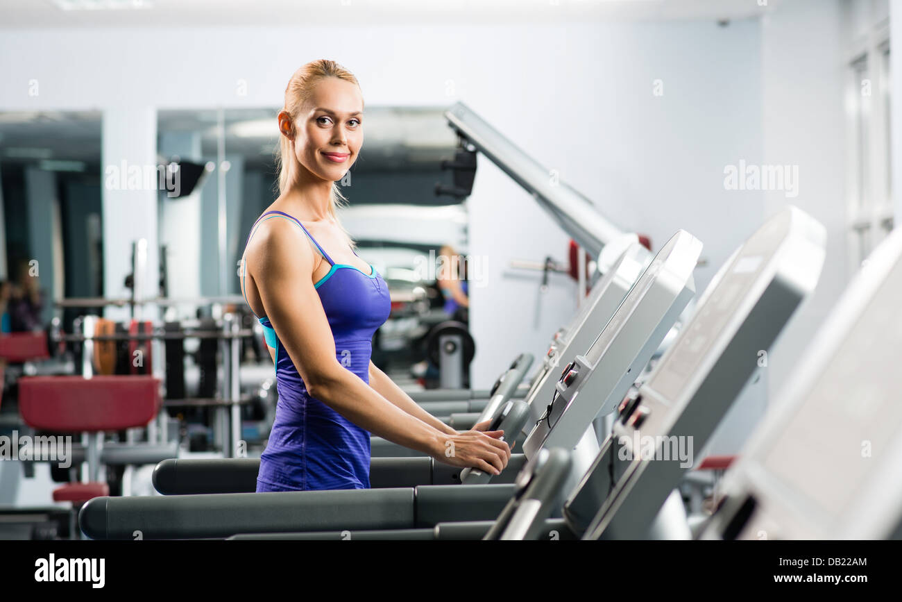 attractive young woman runs on a treadmill Stock Photo Alamy