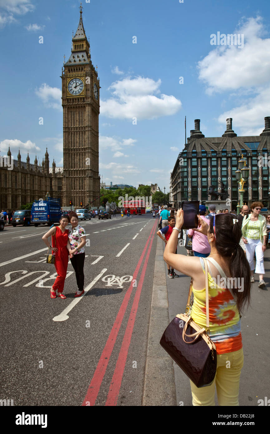 Chinese Tourists Pose In Front Of The Houses Of Parliament, London, England Stock Photo