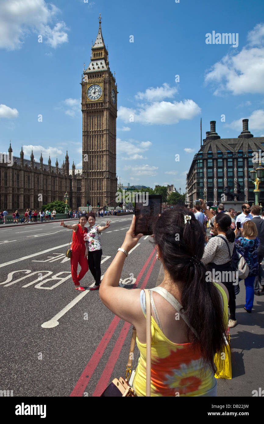 Chinese Tourists Pose In Front Of The Houses Of Parliament, London, England Stock Photo