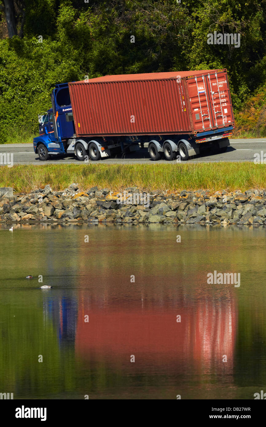 Container truck beside Otago Harbour near Port Chalmers, Dunedin, Otago, South Island, New Zealand Stock Photo