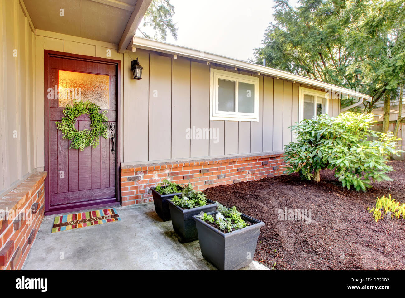 Brown grey house exterior with front door and spring landscape Stock ...