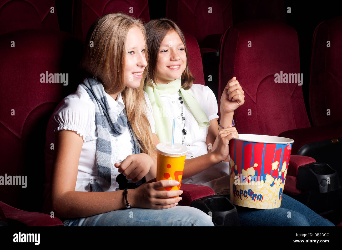 two beautiful girls watching a movie at the cinema Stock Photo Alamy