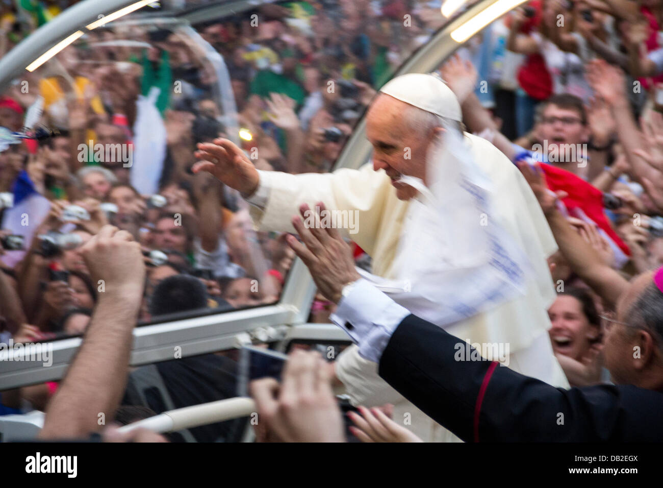Pope Francisco in his first apparition in the car, unprotected, accompanied by hundreds of faithful in Rio de Janeiro, Brazil. Stock Photo