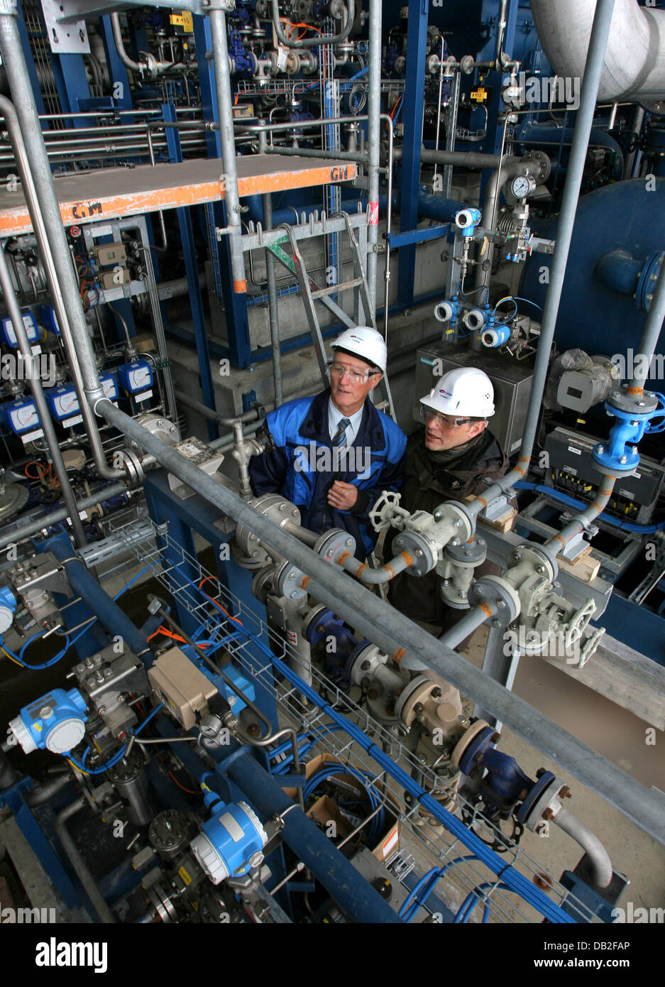 Technologists Christian Schmidt (L) and Anton Althapp check the valve control system at the first commercial next-generation-biofuel production plant under construction at CHOREN Industries GmbH Freiberg, Germany, 17 December 2007. From 2008 on, up to 18 million litres of Biomass To Liquids (BTL) biofuel will be gained from wood and plant waste. The first large-quantity BTL plant m Stock Photo