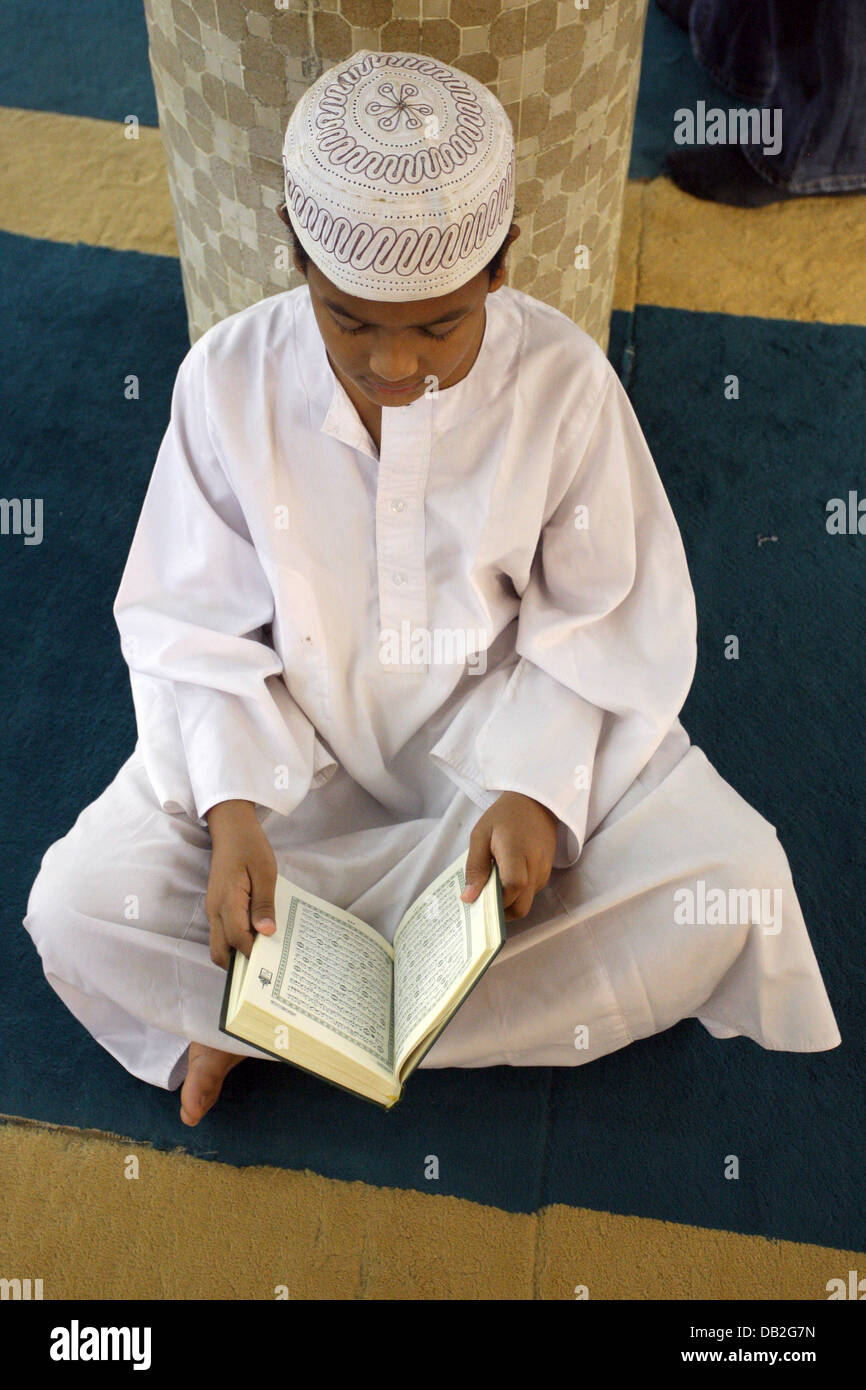 A young Sudanese Muslim reads the Koran at a mosque in Khartoum, Sudan ...