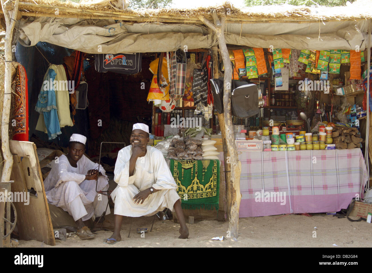 Two man sit outside a market booth in Bindisi in Western Darfur, Sudan, 10 December 2007. The number of 17,000 internal refugees living in Bindisi is equivalent to two-thirds of the local population. Photo: Peter Steffen Stock Photo
