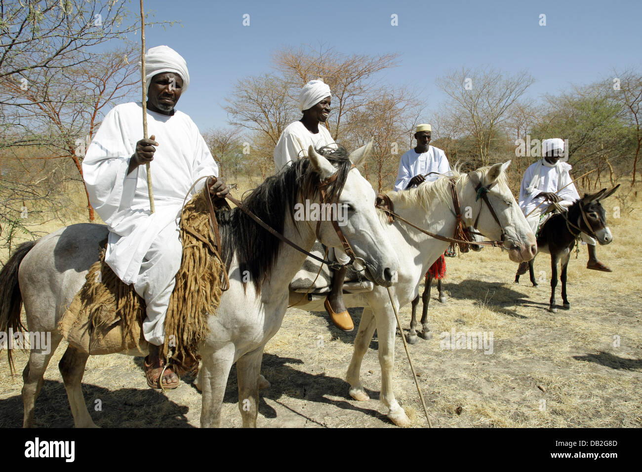 Villagers sit on their horses and cater for security on the roads near the village of Buru in Western Dafur, Sudan, 11 December 2007. Photo: Peter Steffen Stock Photo