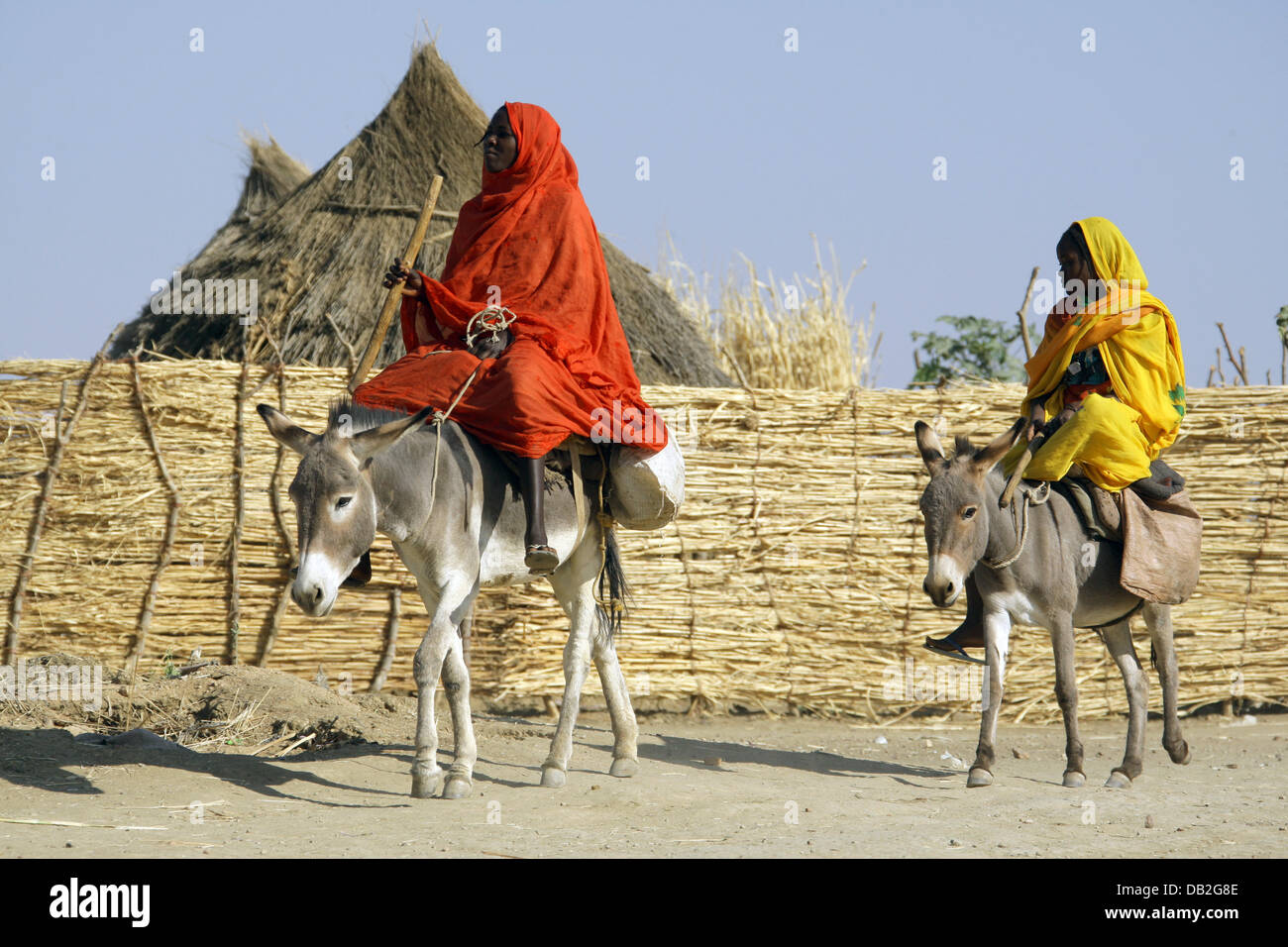 Two female riders sit on their donkeys in Mukjar in Western Dafur, Sudan, 11 December 2007. Photo: Peter Steffen Stock Photo