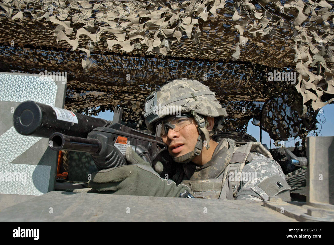 A soldier of the 3rd US Stryker Brigade Combat Team secures the surroundings with his FN 202 during a US-patrol carbine during a search operation in Bagdad, Iraq, March 2007. Photo: Carl Schulze Stock Photo