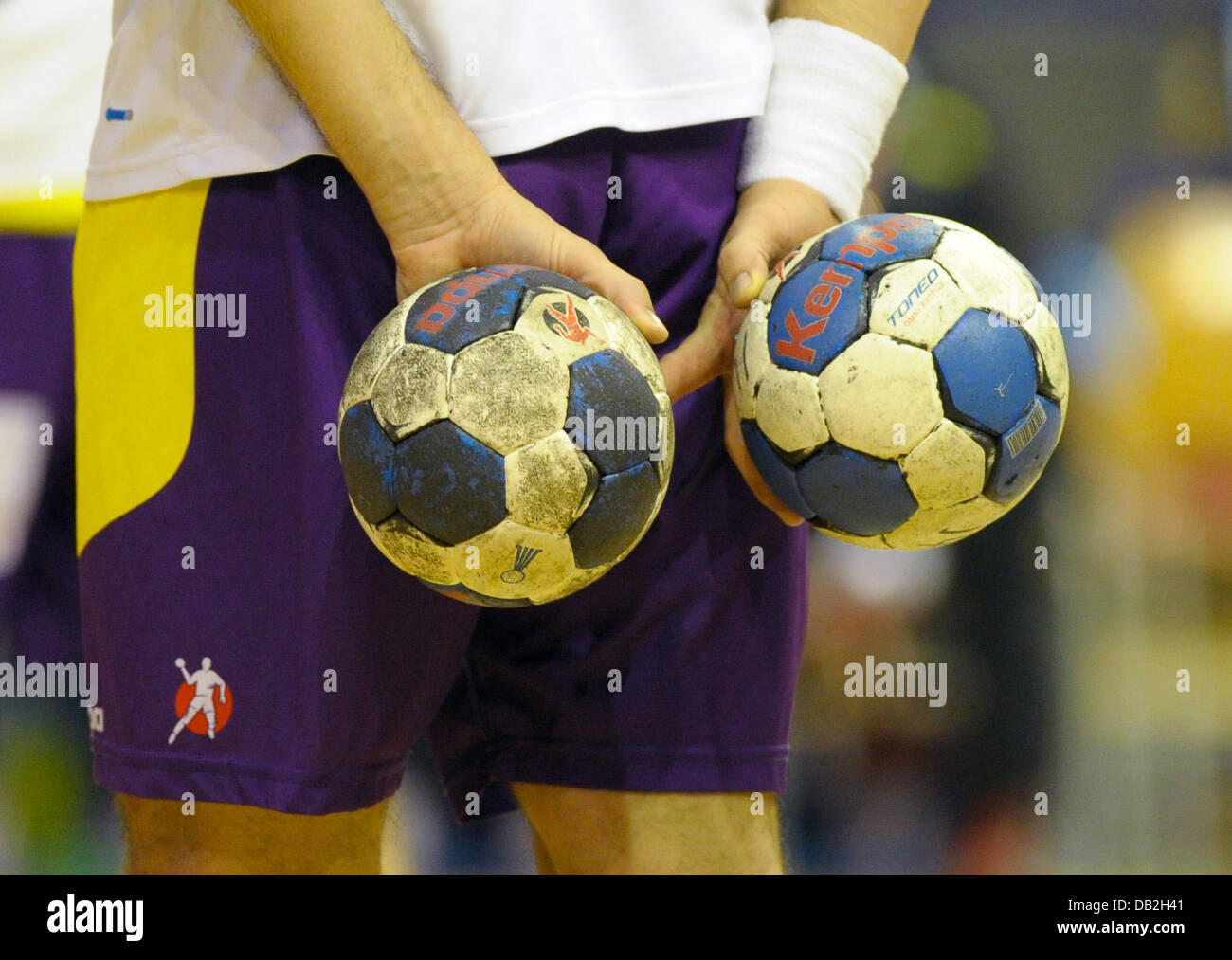 A Berlin player holds two balls at the same time during the German Handball- Bundesliga match