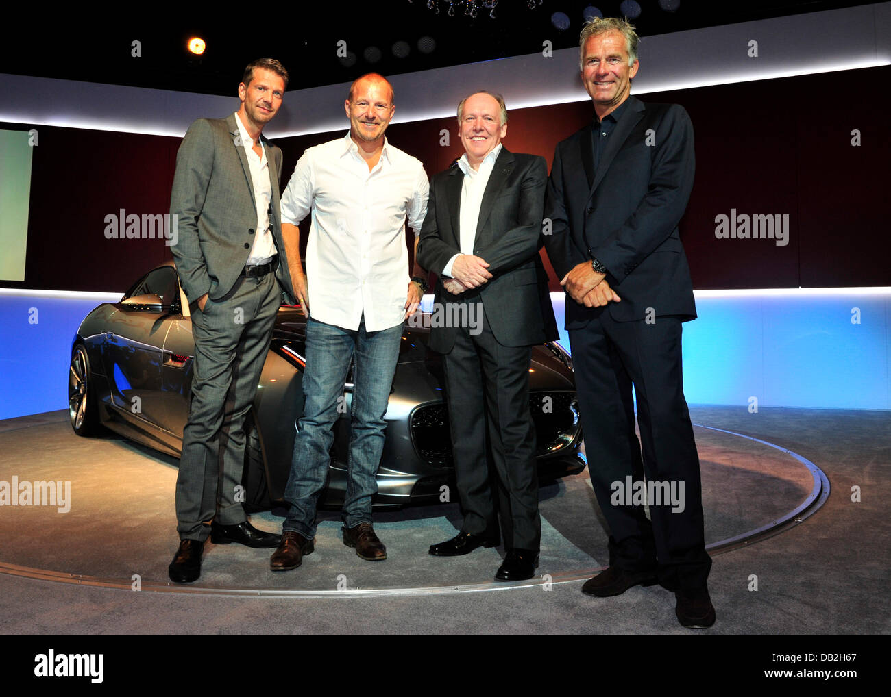 German actors Kai Wiesinger (from L) and Heino Ferch stand together with Ian Callum, head designer for Jaguar, and former race driver Christian Danner stand next to the concept sports car Jaguar C-X16 after its presentation at Palais Thurn und Taxis at the International Motor Show IAA in Frankfurt Main, Germany, 12 September 2011. From 15 to 25 September 2011 exhibitors from all ov Stock Photo