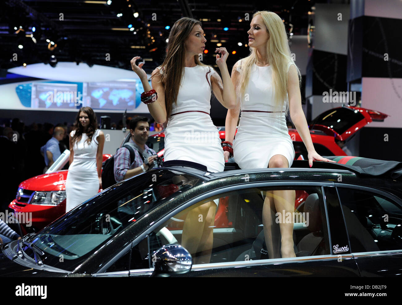 Hostesses sit on a Fiat at the International Motor Show IAA in Frankfurt,  Germany, 13 September 2011. The International Motor Show IAA in Frankfurt  is one of the world's top motor shows.