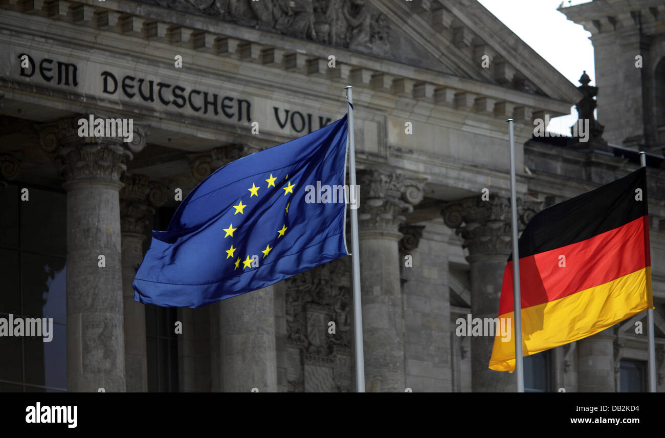 The European and the German flag are seen in front of the German Reichstag in Berlin, Germany, 15 September 2011. According to the European Commission, the economy of the 17 European states will hardly increase in the second half of 2011. Photo: KAY NIETFELD Stock Photo
