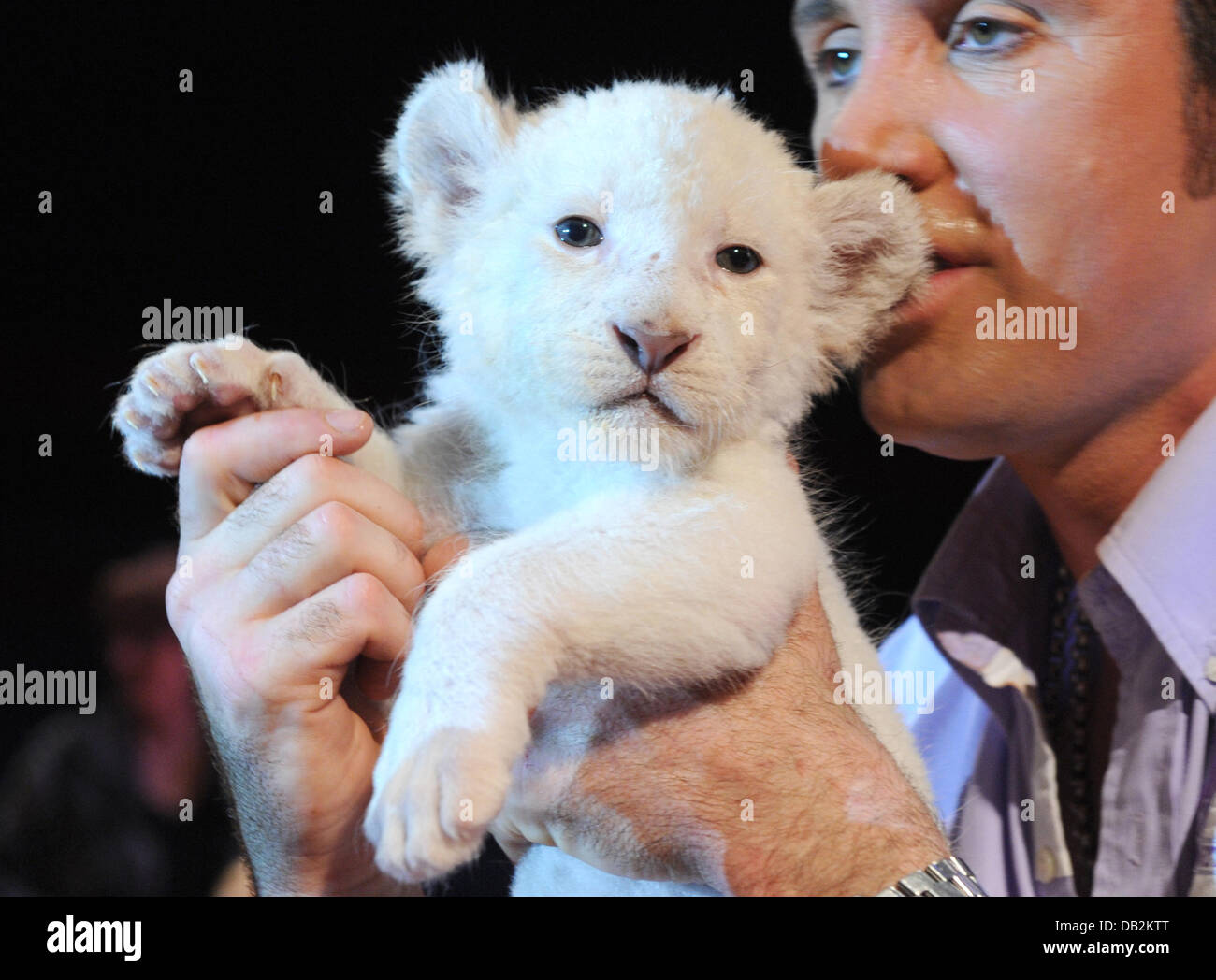Lion trainer Martin Lacey jr. carries a white lion cub during a press call at the Circus Krone