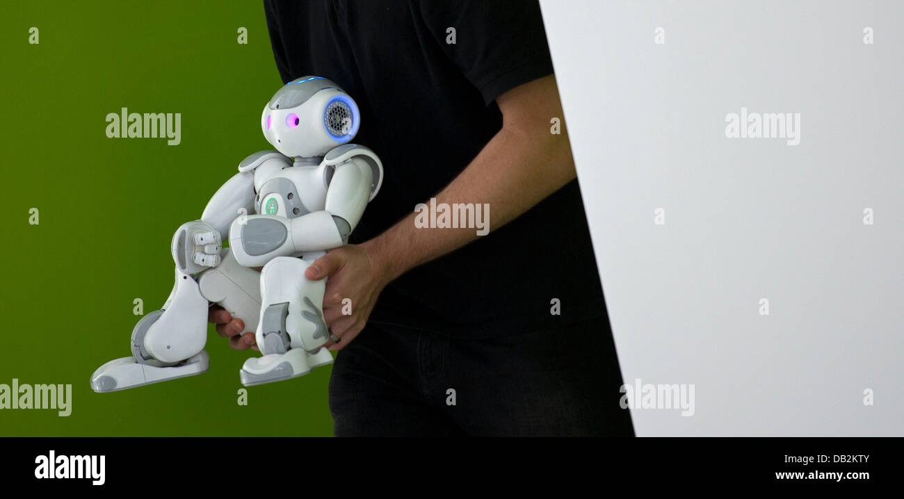 A member of the informatics faculty at the technical university presents the roboter chuck at a press conference during the real estate fair 'Expo Real' in Dresden, Germany, 16 September 2011. Chuck is meant to advertise the state of Saxony as well as the cities of Dresden, Chemnitz and Leipzig under the motto 'Ideas for the future'. Photo: ARNO BURGI Stock Photo