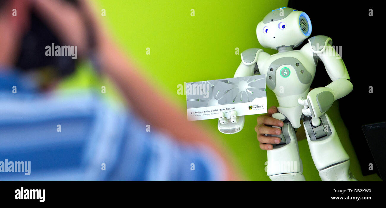 A member of the informatics faculty at the technical university presents the roboter chuck at a press conference during the real estate fair 'Expo Real' in Dresden, Germany, 16 September 2011. Chuck is meant to advertise the state of Saxony as well as the cities of Dresden, Chemnitz and Leipzig under the motto 'Ideas for the future'. Photo: ARNO BURGI Stock Photo