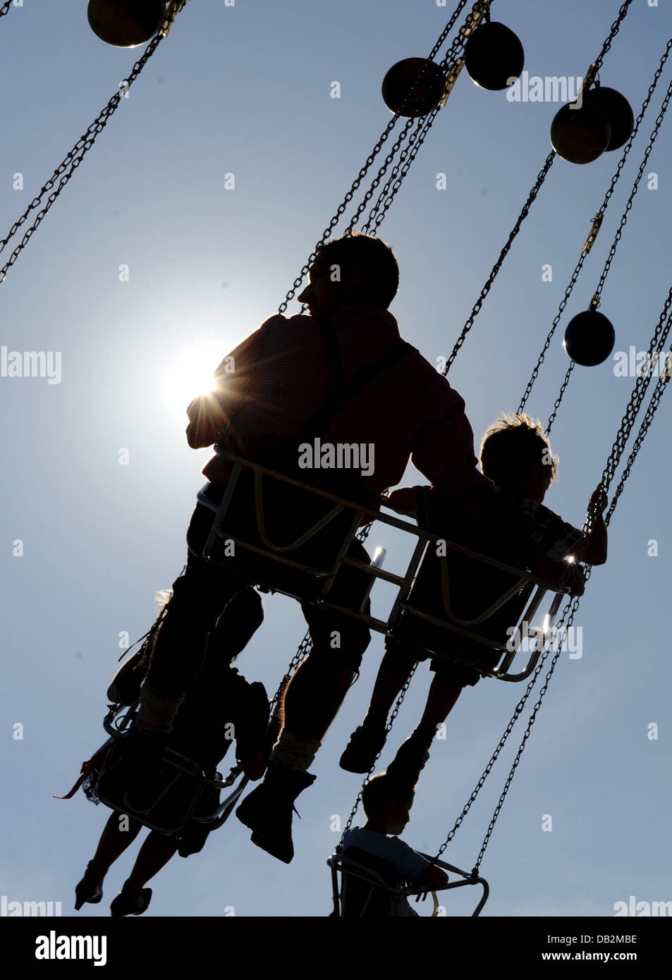 Visitors ride the flying swings at Oktoberfest on the Theresienwiese in ...
