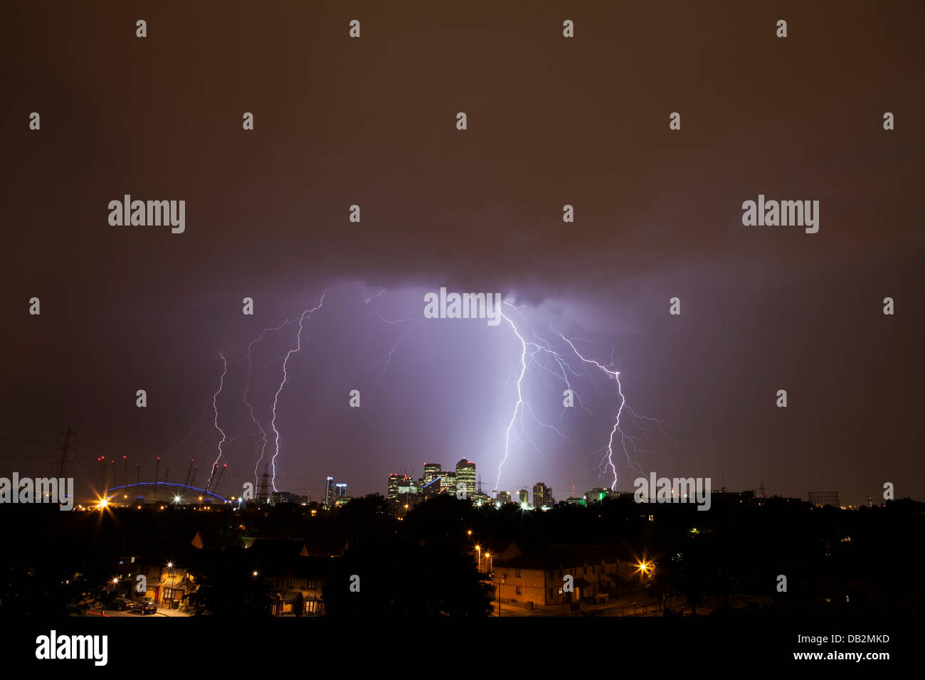 London, UK. 23rd July, 2013. Lightning strikes over London with the Docklands lit up in front. The pictures of the storm were taken just after midnight this morning.  Credit:  Vitor Da Silva/Alamy Live News Stock Photo