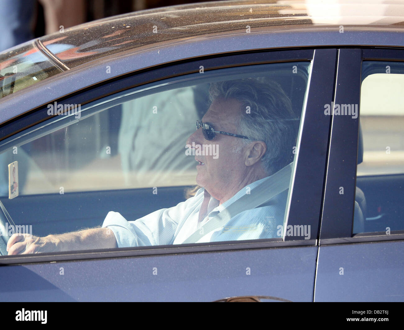 Dustin Hoffman gets into his car after shopping at Barney's Of New York
