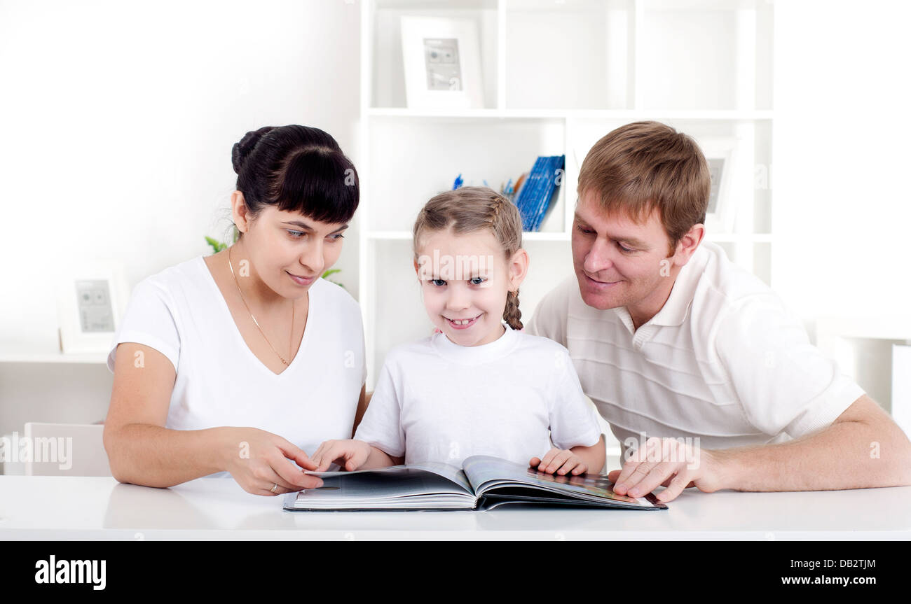 Family reading a book together Stock Photo - Alamy