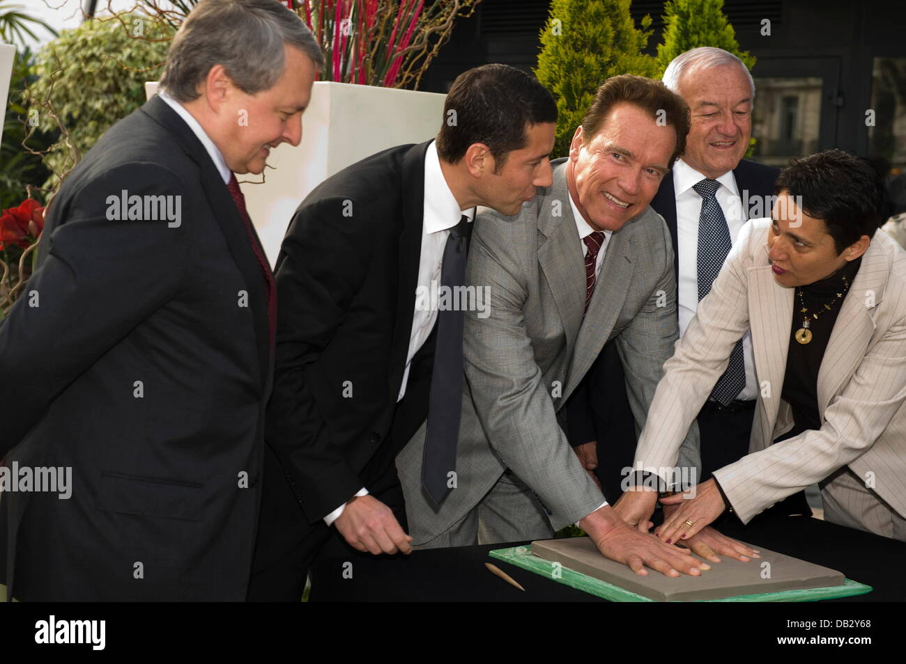 Paul Zilk, Ceo of Reed Midem, Arnold Schwarzenegger and Cannes Mayor Bernard Brochand  attend a 'Handprint Ceremony' during MIPTV Cannes, France - 04.04.11 Stock Photo