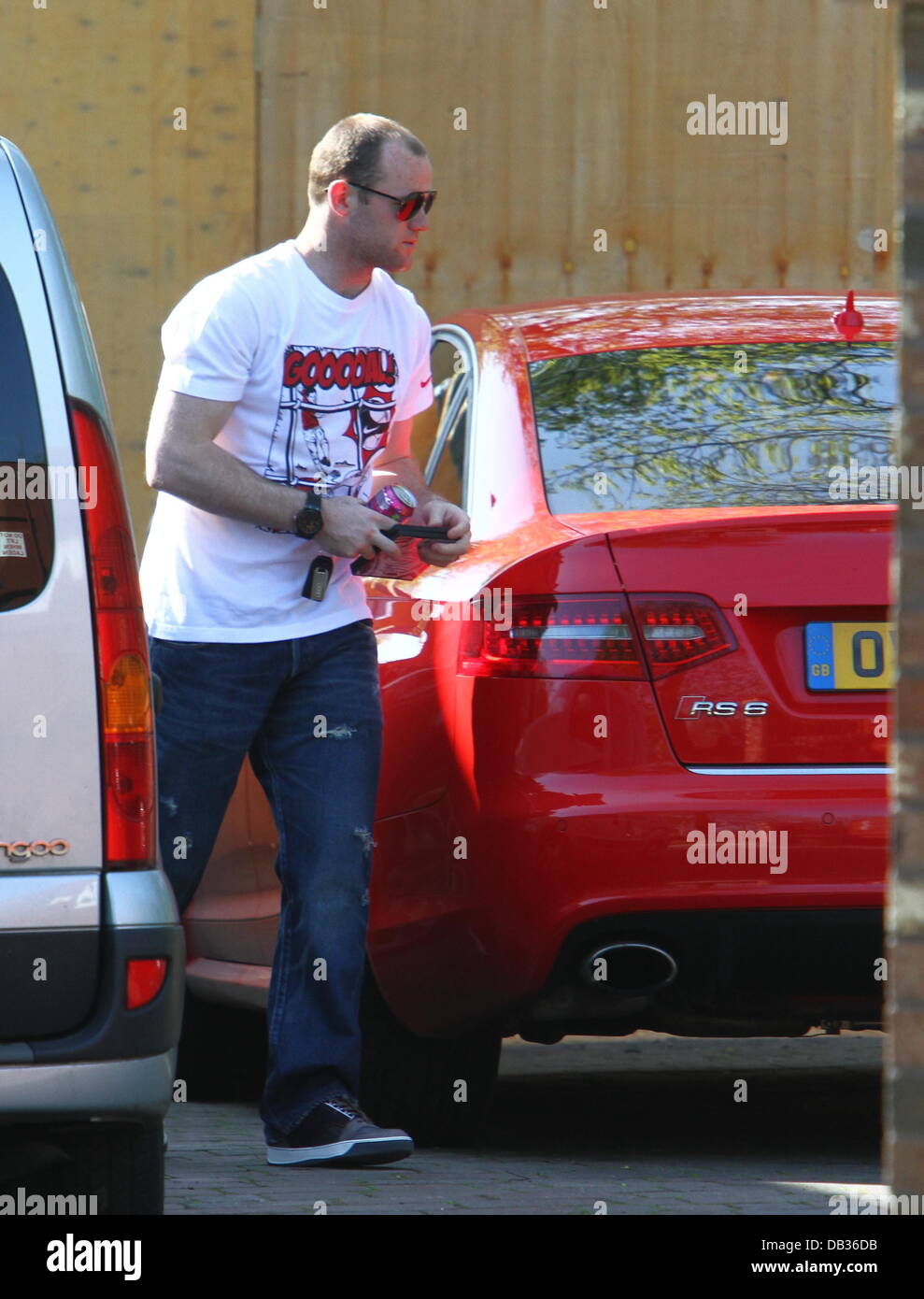 Wayne Rooney getting into his car at his wife's parents' house wearing a Nike t-shirt with the word 'Goooal!' written on it. Liverpool, England - 09.04.11 Stock Photo