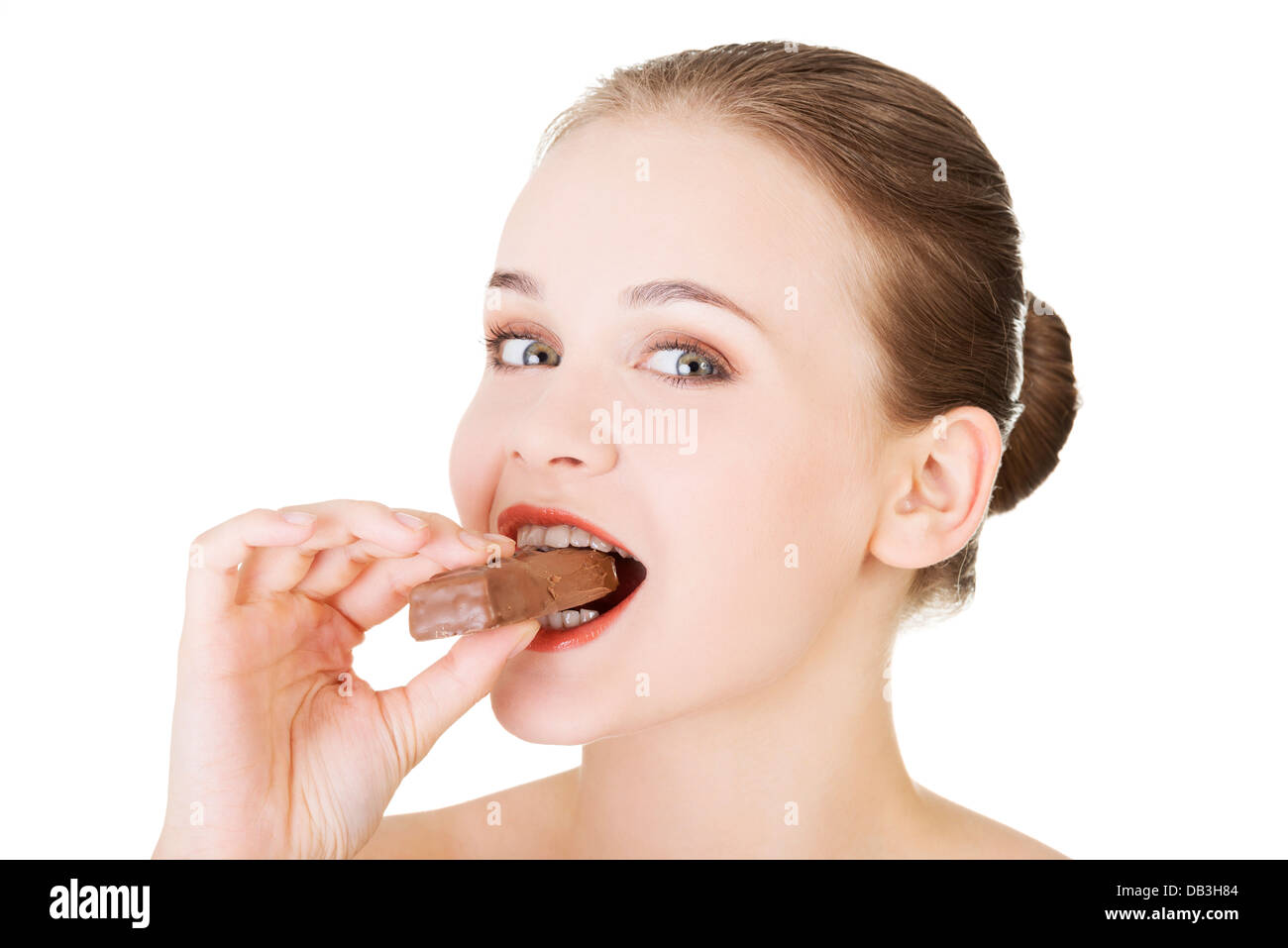 Young beautiful woman eating bar, isolated on white Stock Photo