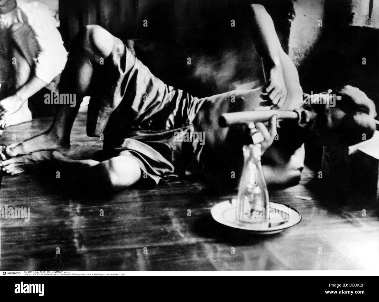 drugs and dope, opium, junkie smoking opium pipe, 20th century, historic, historical, addiction, lying, drug, drugs, bamboo, addicted, man, addict, addicts, 1960s, people, men, male, Additional-Rights-Clearences-Not Available Stock Photo