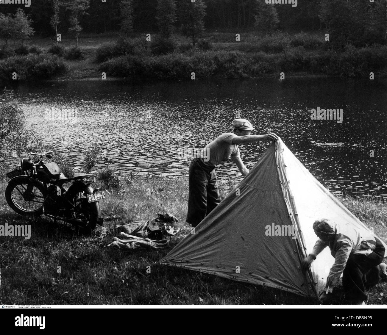leisure time, camping, teenager putting up a tent on a riverside, 1950s, , Additional-Rights-Clearences-Not Available Stock Photo
