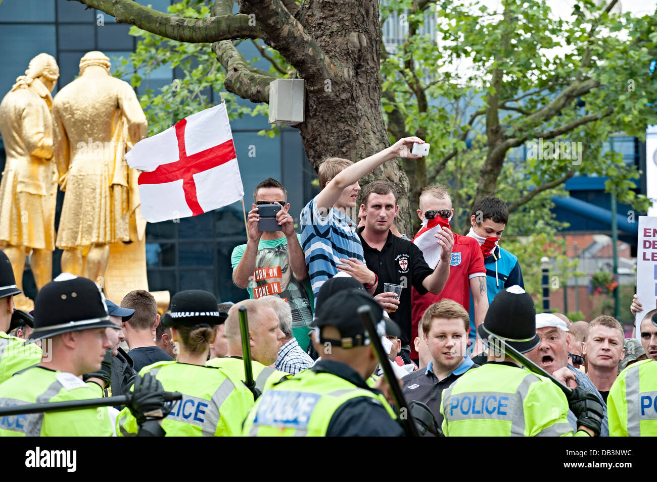 english defence league edl protest birmingham july 20th 2013 eld hold flags up and challenge riot police Stock Photo