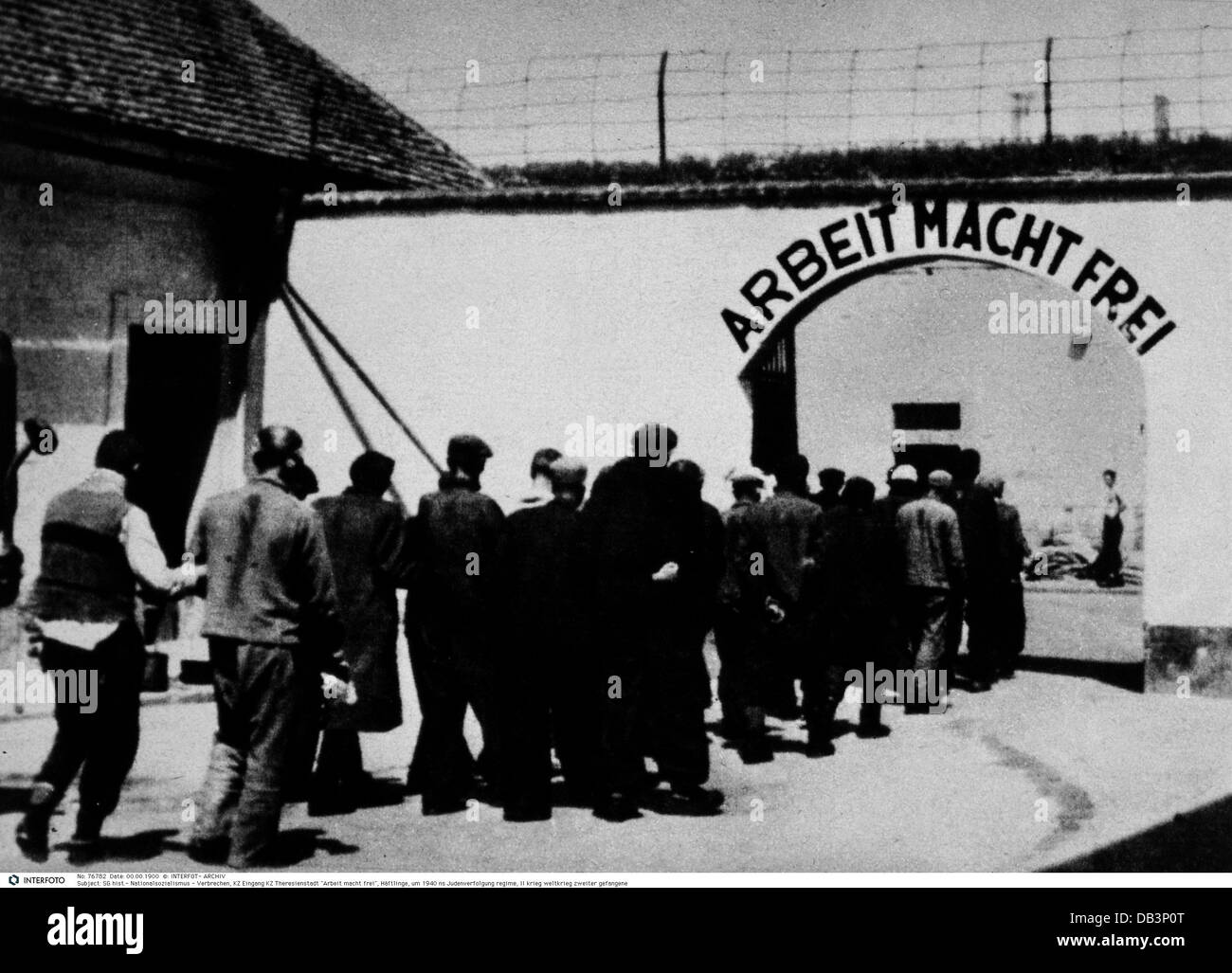 National Socialism / Nazism, crimes, Theresienstadt concentration camp, inmates at the entrance, 'Arbeit macht frei' (work makes free), circa 1942, Additional-Rights-Clearences-Not Available Stock Photo