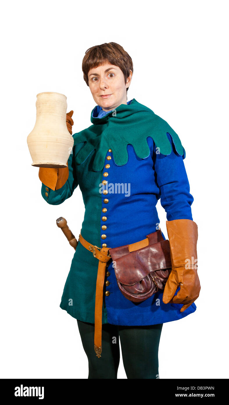 Happy young woman in a medieval male blue-green dress holding a white jug on isolated background Stock Photo