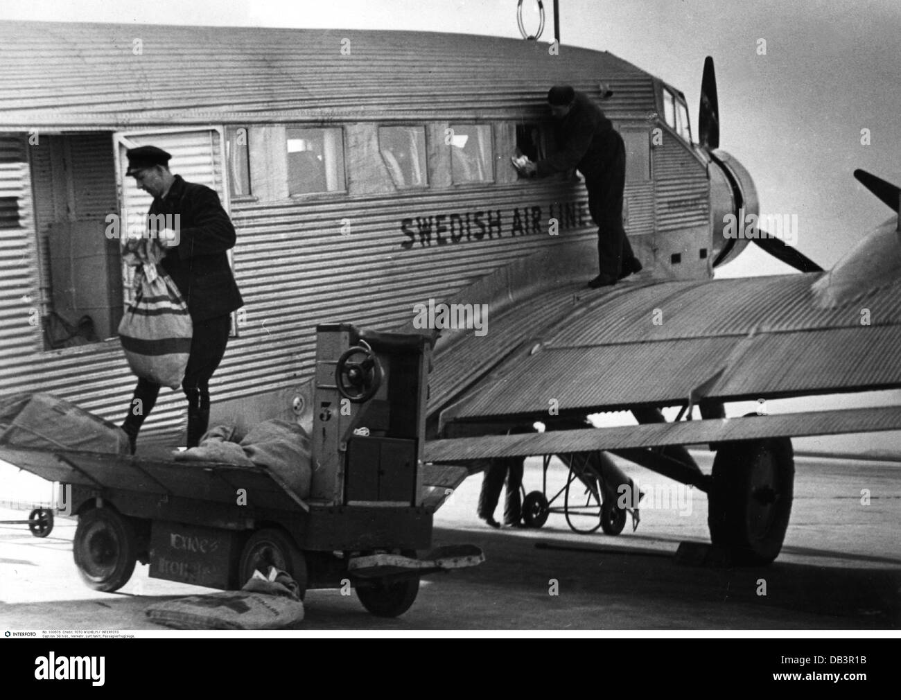 transport / transportation,aviation,passenger plane,Junkers Ju 52,Swedish Air Lines,airport,Zweden,Netherlands,1946,1940s,40s,20th century,historic,historical,Holland,transport aircraft,transport plane,transport,transport aircraft,transport planes,transports,commercial aircraft,commercial aircraft,airplane,aeroplane,plane,airplanes,aeroplanes,planes,airfield,airfields,service,cargo,loading,mail bag,mail bags,airmail,air-mail,by air-mail,clean,clean up,cleaning,propeller plane,propeller-driven aircraft,1930s,people,Additional-Rights-Clearences-Not Available Stock Photo