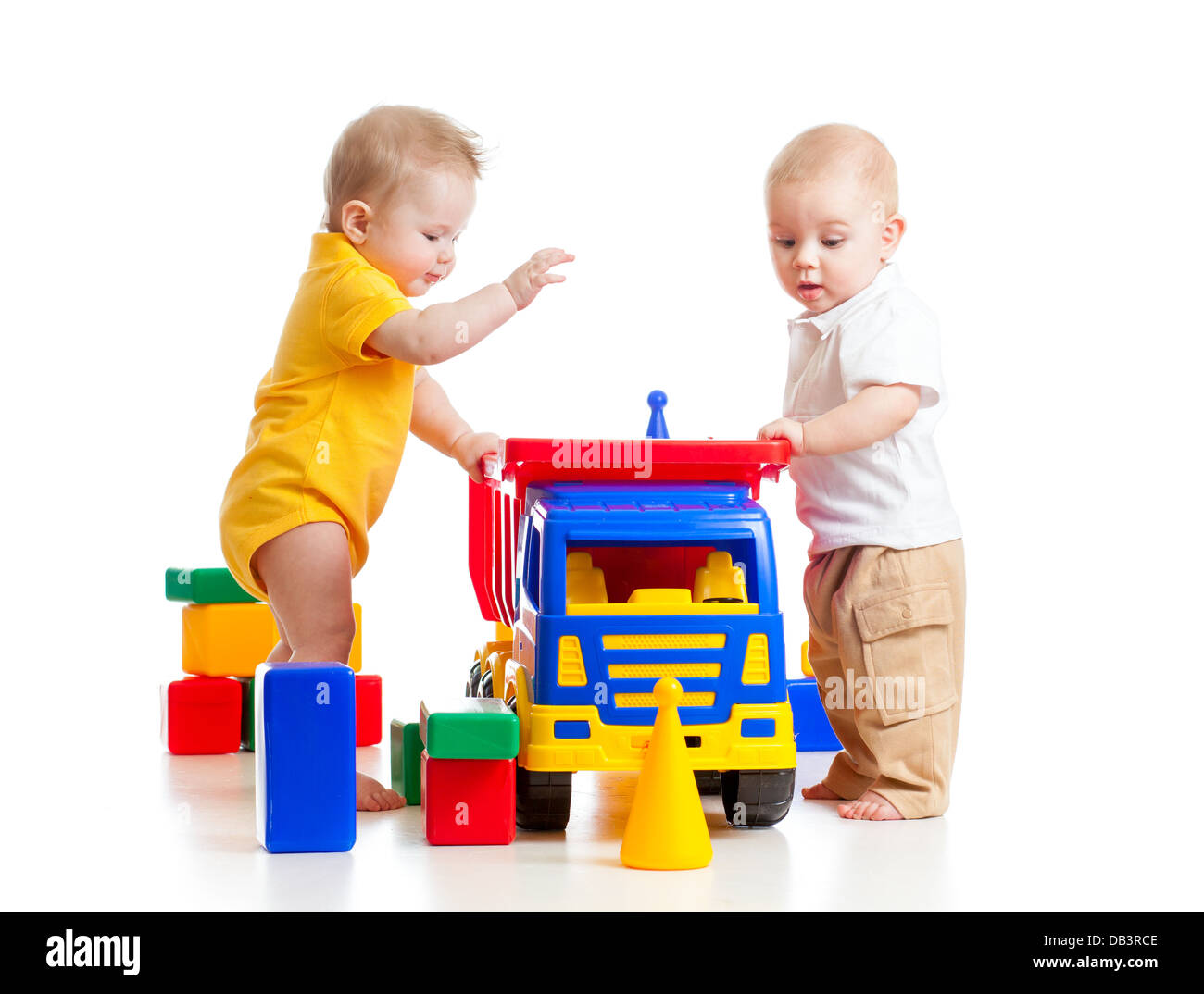 two little kids playing with color toys Stock Photo - Alamy