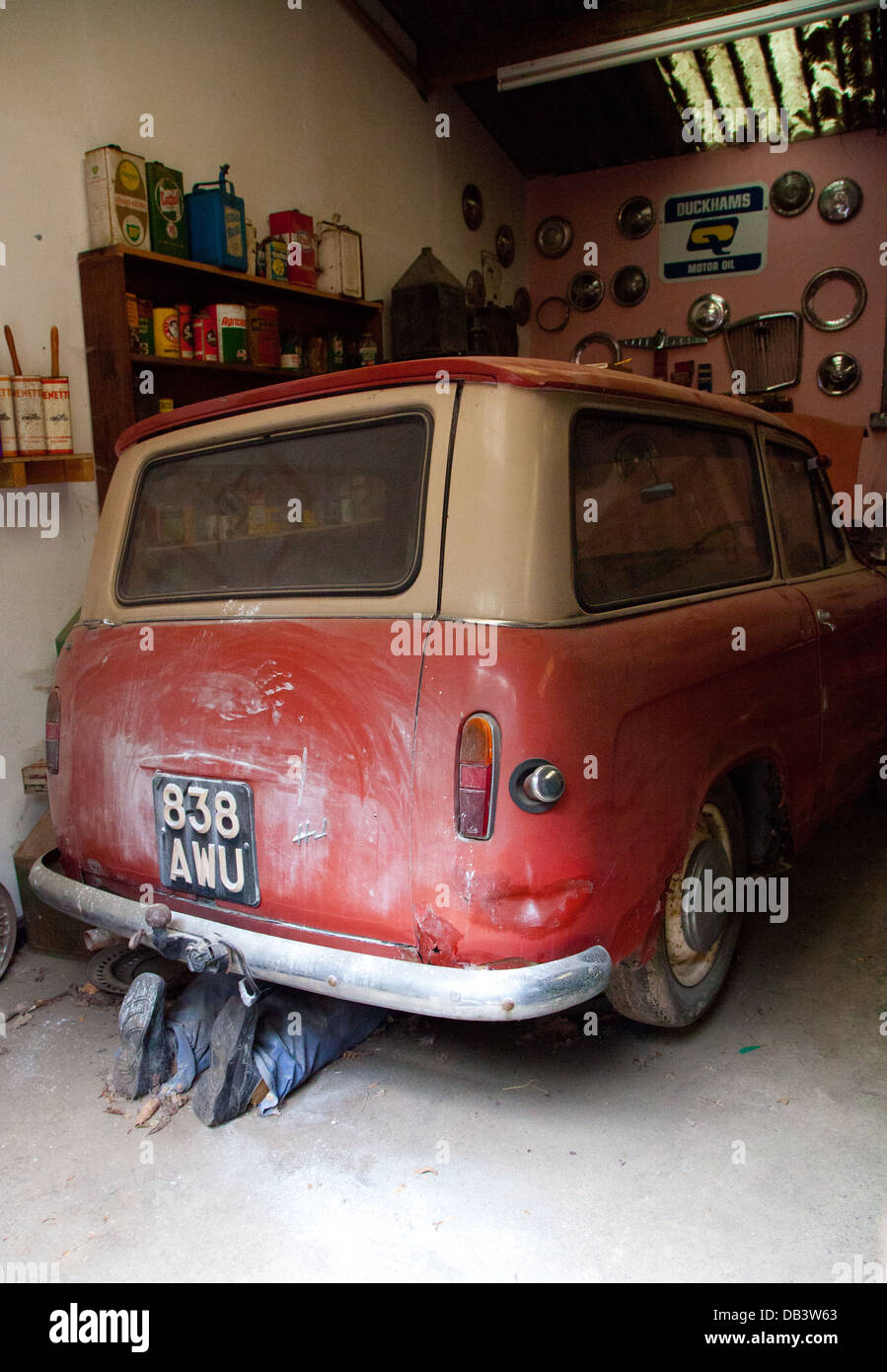 Interior of a vintage garage with car, vintage spares in original packaging and signs on shelf in Cae Dai 1950 Museum, Denbigh Stock Photo