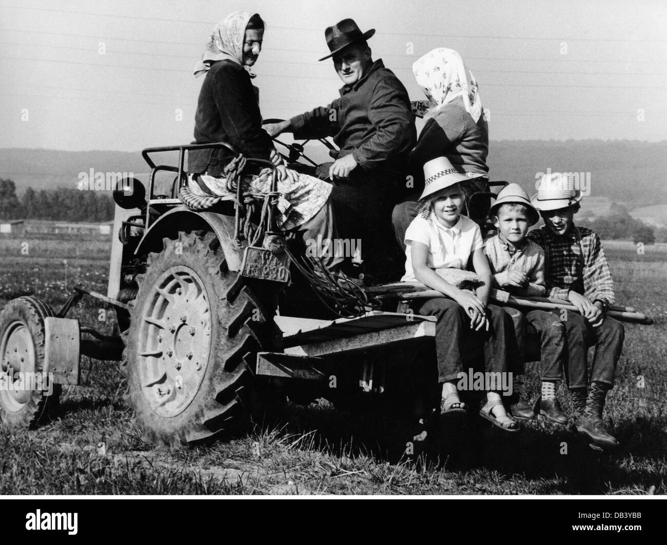 agriculture, farmers, familiy sitting on the tractor, circa 1970 Stock