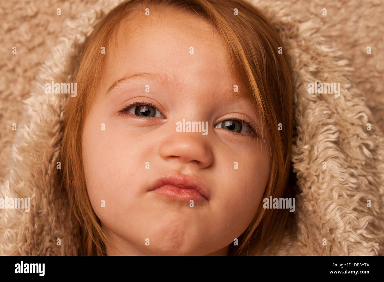 Small Child Puckering Lips Blanket Stock Photo