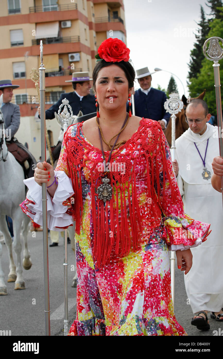 Spanish women wearing gypsy flamenco dresses making the Catholic