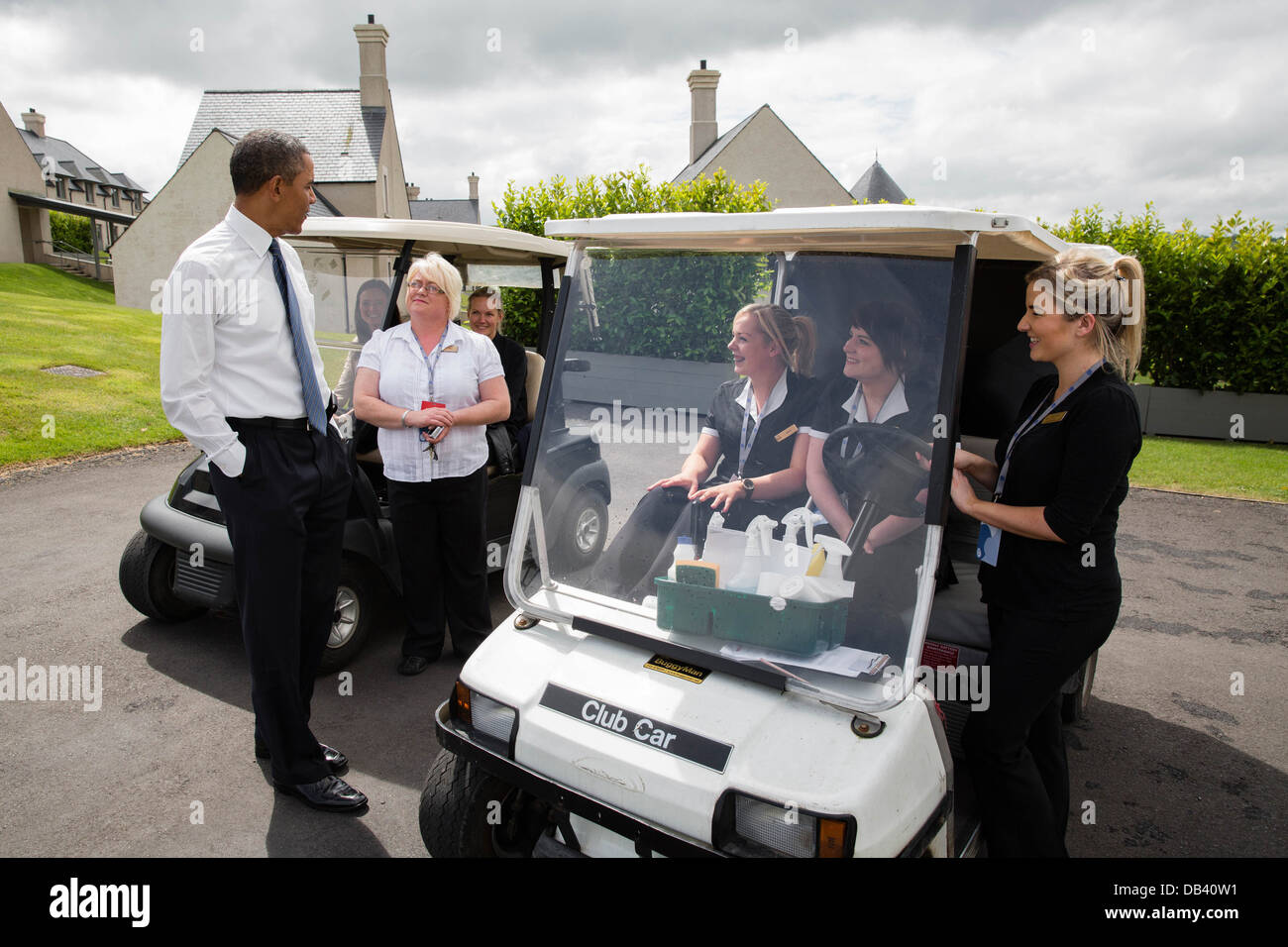 President Barack Obama talks with housekeeping staff outside of a lodge at the Lough Erne Resort during the G8 Summit in Enniskillen, Northern Ireland, June 17, 2013. Stock Photo