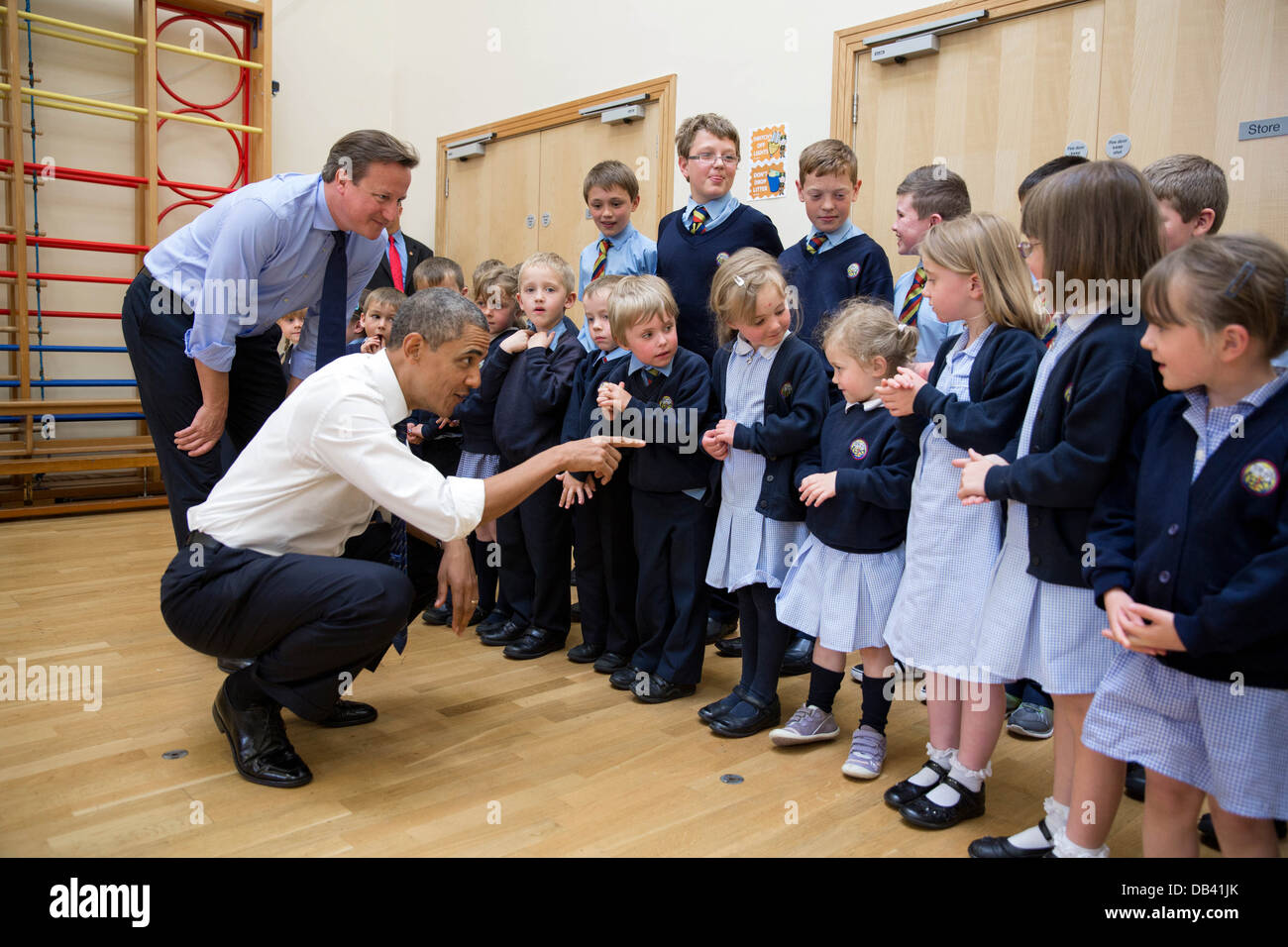 President Barack Obama and British Prime Minister David Cameron visit with students while touring Enniskillen Primary School in Stock Photo
