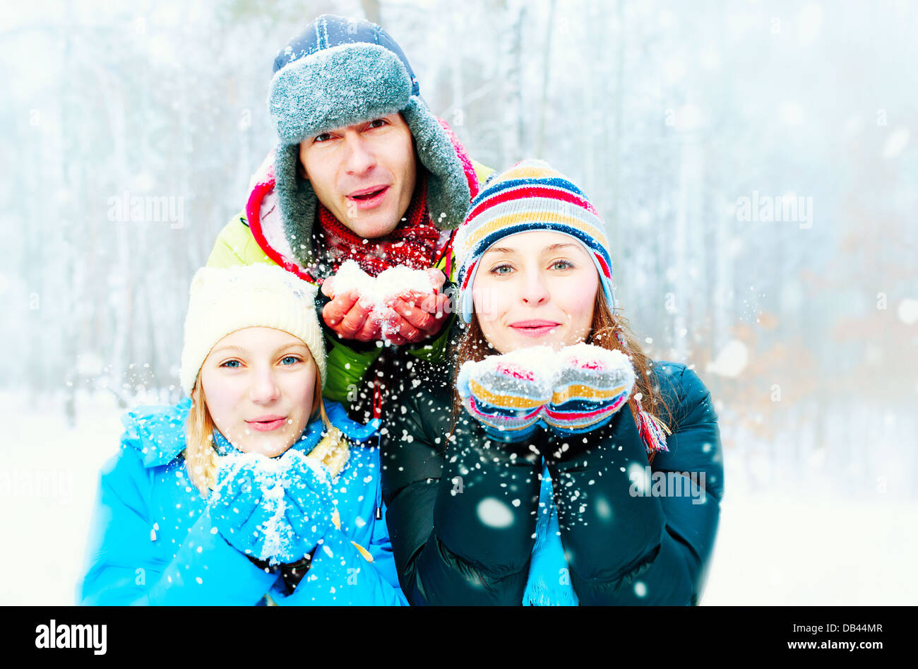 Family Outdoors. Happy Family Blowing Snow Stock Photo - Alamy
